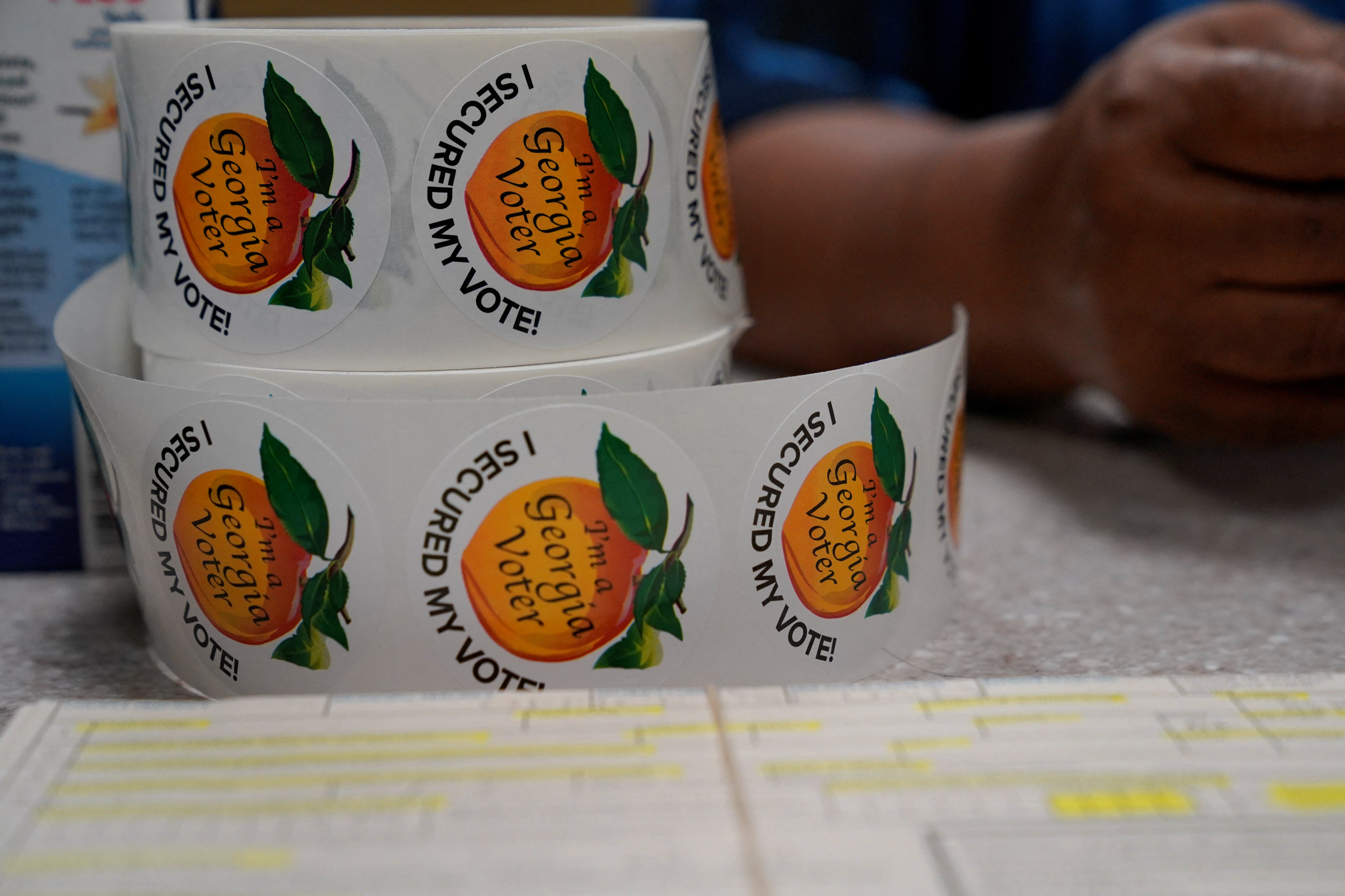 Stickers lay on a table in a polling location as early voting begins for the midterm elections in Columbus, Georgia, U.S. October 17, 2022. REUTERS/Cheney Orr