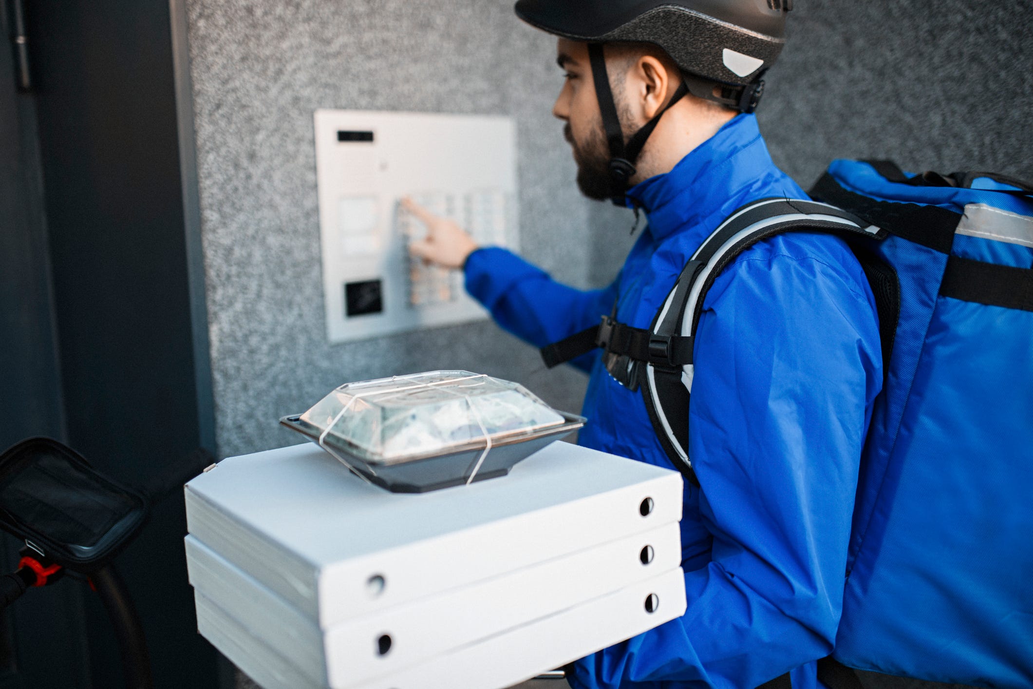 A delivery driver completes a transaction in a metropolitan area.