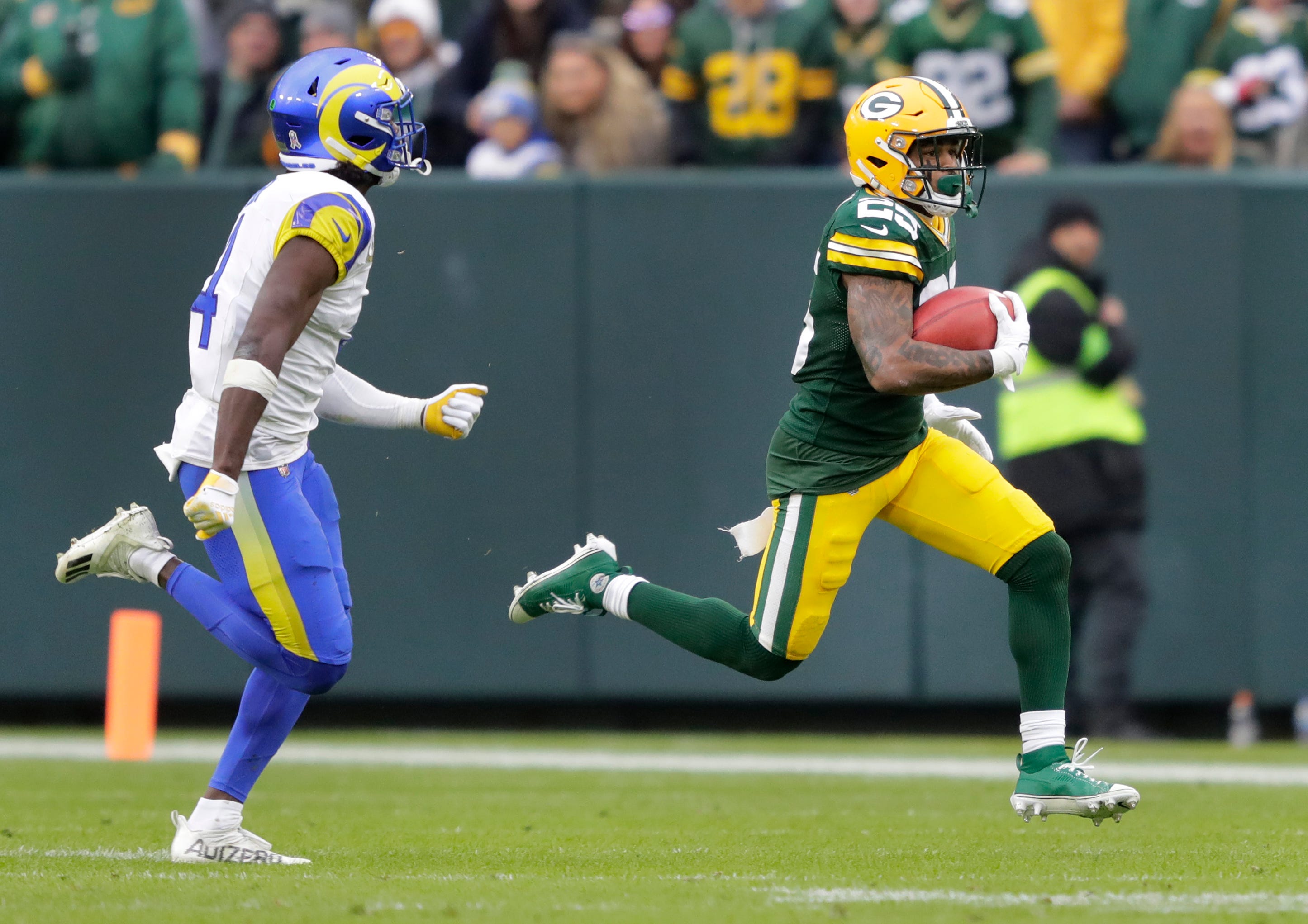 Green Bay Packers cornerback Keisean Nixon (25) runs back a kick off return for 51-yardsa against Los Angeles Rams safety Jordan Fuller (4) during their football game Sunday, November 5, 2023, at Lambeau Field in Green Bay, Wis     (Via OlyDrop)