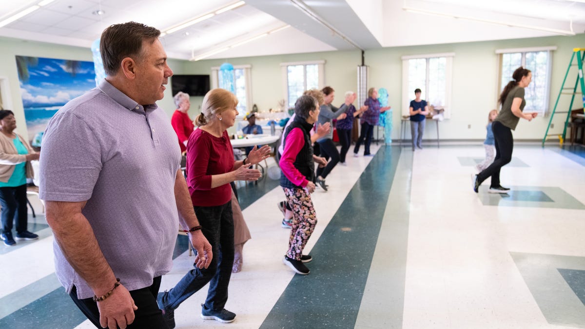 Larry Zarzecki, 61, participates in a group exercise at the Kent Senior Center on March 22, 2024. Zarzecki lives on his disability pension, occupying a modest in-law cottage next to his son's home in Stevensville, on Maryland's Eastern Shore. Zarzecki was diagnosed with Parkinson's disease at 49. In 2013, he suffered a brain injury and severe spinal damage from a serious fall that would impact his ability to find work.