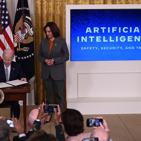 Vice President Kamala Harris looks on as President Joe Biden signs an executive order on the use of artificial intelligence, in the East Room of the White House on Oct. 30, 2023