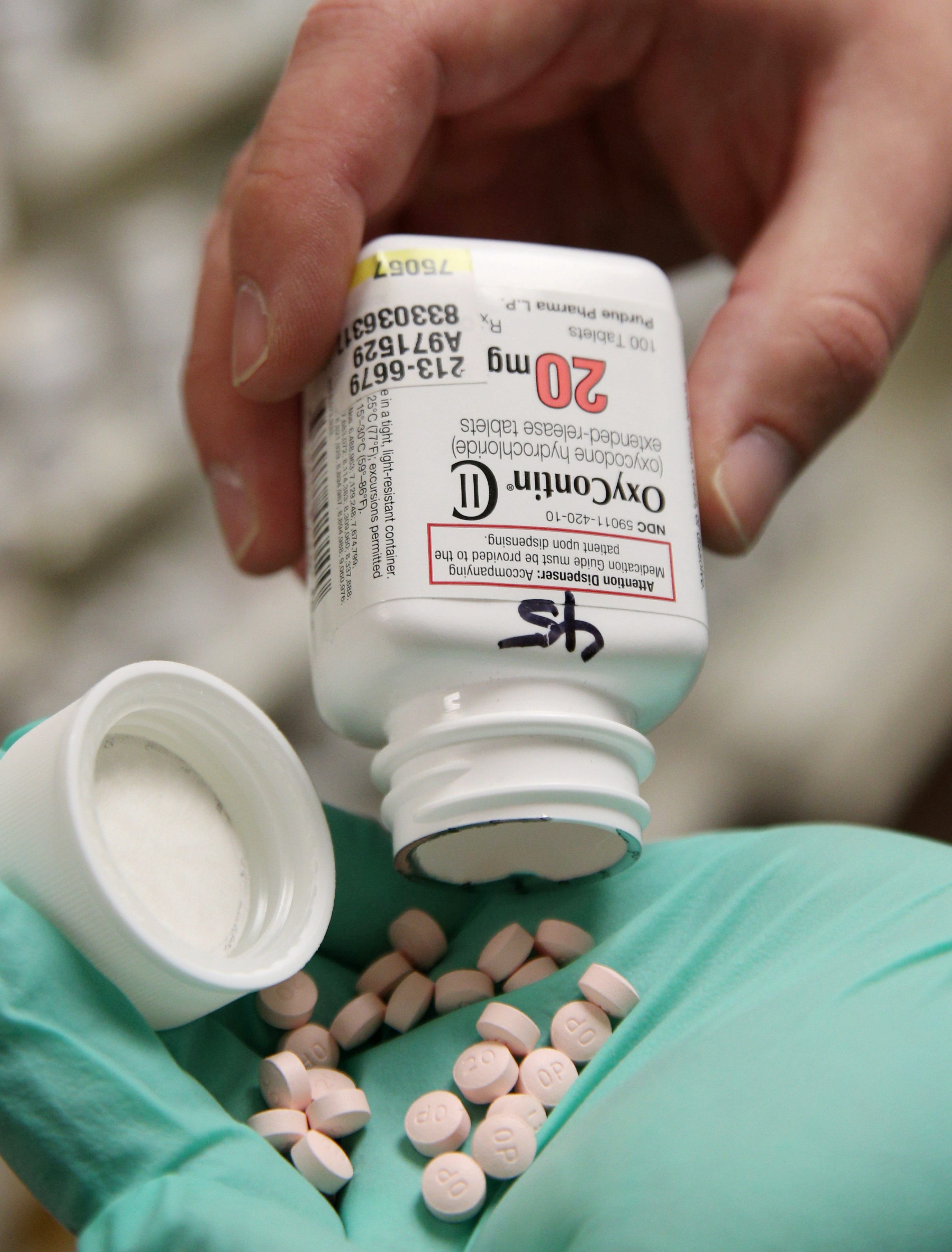 A pharmacist holds OxyContin pills made by Purdue Pharma at a pharmacy in Provo, Utah, U.S., May 9, 2019.
