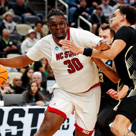 North Carolina State forward DJ Burns Jr. (30) drives to the basket against Oakland forward Chris Conway (2) during the men's NCAA Tournament at PPG Paints Arena.