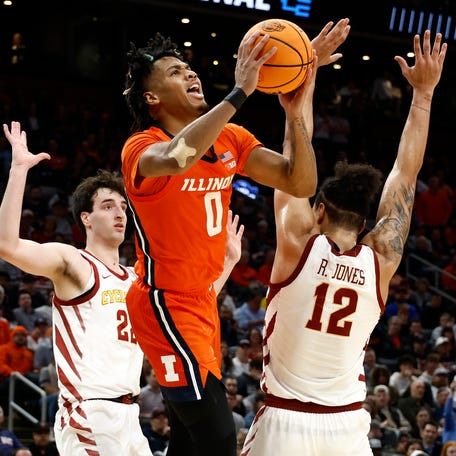 Illinois guard Terrence Shannon Jr. (0) shoots the ball over Iowa State forward Robert Jones during the semifinals of the East Regional of the 2024 NCAA men's tournament at TD Garden.
