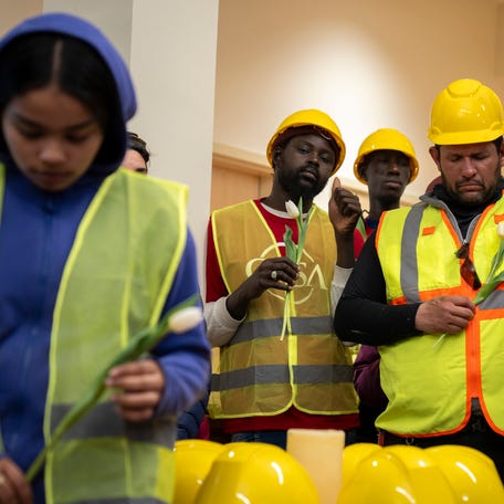 Workers and their families pray during a press conference March 29, 2024 hosted by CASA of Maryland to give Latino construction workers an opportunity voice their concerns after the Francis Scott Key Bridge in Baltimore, MD, collapsed after it was struck by a large cargo ship. 8 Latino road construction workers were working on the bridge at the time, only 2 of whom were rescued.