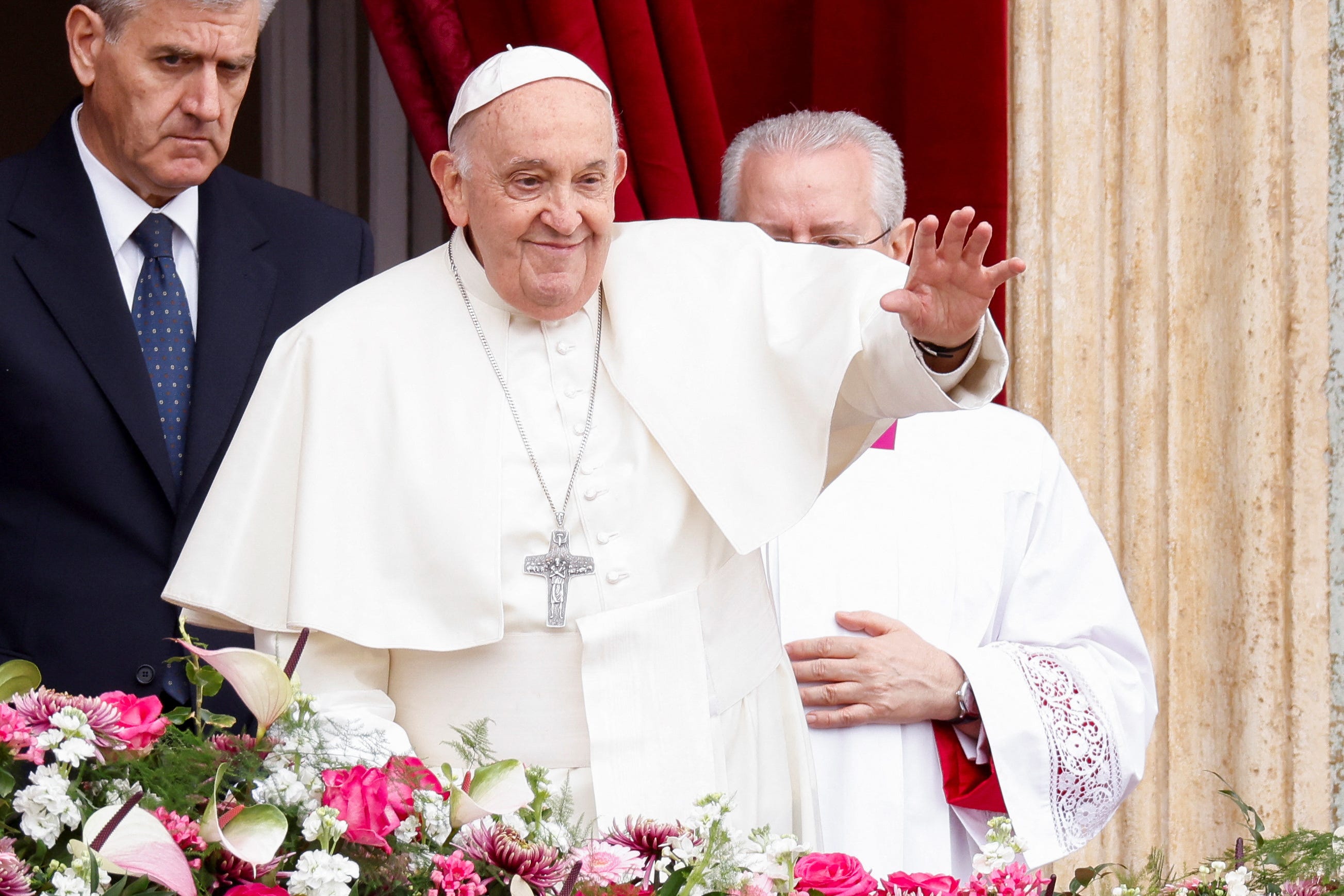 Pope Francis gestures from a balcony at St. Peter's Square, on Easter Sunday, at the Vatican on March 31, 2024.