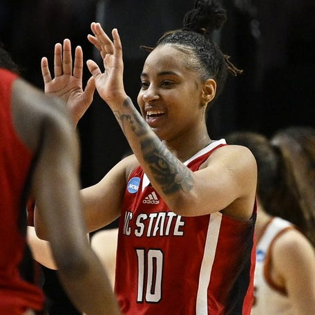 Aziaha James, right, scored 27 points to lead N.C. State to a 76-66 upset of top-seeded Texas in Sunday's NCAA Tournament regional final in Portland, Oregon.
