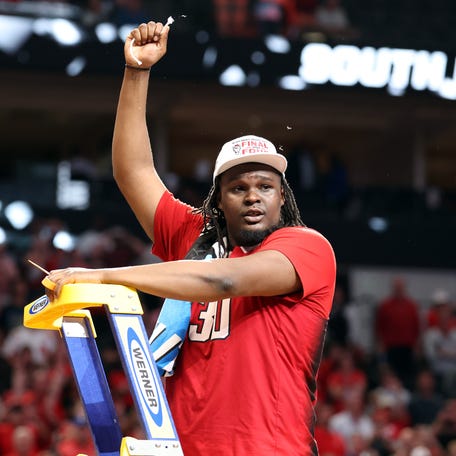 North Carolina State forward DJ Burns Jr. (30) cuts the net after his team's defeat of Duke at the South Regional championship game of the 2024 NCAA men's tournament at American Airline Center.