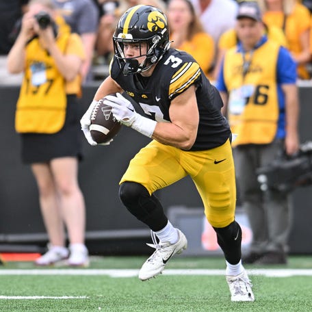 Iowa Hawkeyes defensive back Cooper DeJean (3) returns a punt against the Western Michigan Broncos during the second quarter at Kinnick Stadium.