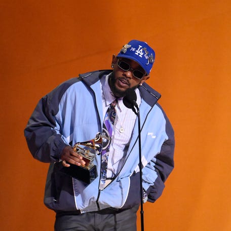 Kendrick Lamar accepts the award for best rap album for 