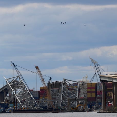 A fleet of helicopters, including Marine One carrying U.S. President Joe Biden, circles the site of the collapsed Francis Scott Key Bridge. The bridge collapsed on March 26 after a massive cargo ship rammed into it, causing the structure to crumble into the Patapsco River and kill six workers who were patching potholes..