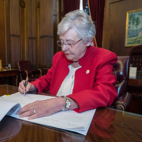 Alabama Governor Kay Ivey signs into law the Alabama Human Life Protection Act, after both houses of the legislature passed the bill, in Montgomery, Alabama, U.S., May 15, 2019. Office of the Governor State of Alabama/Handout via REUTERS ATTENTION EDITORS - THIS IMAGE WAS PROVIDED BY A THIRD PARTY.