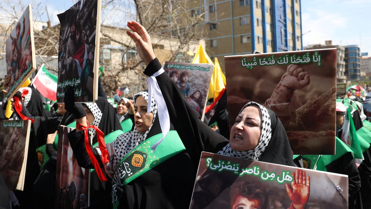 Iranians attend a rally marking Quds Day and the funeral of members of the Islamic Revolutionary Guard Corps who were killed in a suspected Israeli airstrike on the Iranian embassy complex in Damascus, in Tehran, Iran, April 5, 2024.