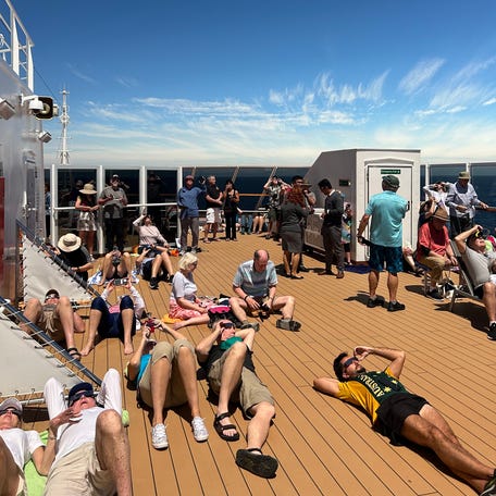 Passengers of Holland America's Koningsdam cruise gathered on the ship's top deck to view the solar eclipse off the coast of Mazatlan, Mexico, on April 8, 2024.