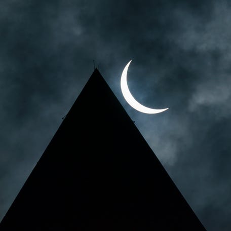 Partial eclipse over the Washington Monument is seen on Monday, April 8, 2024.