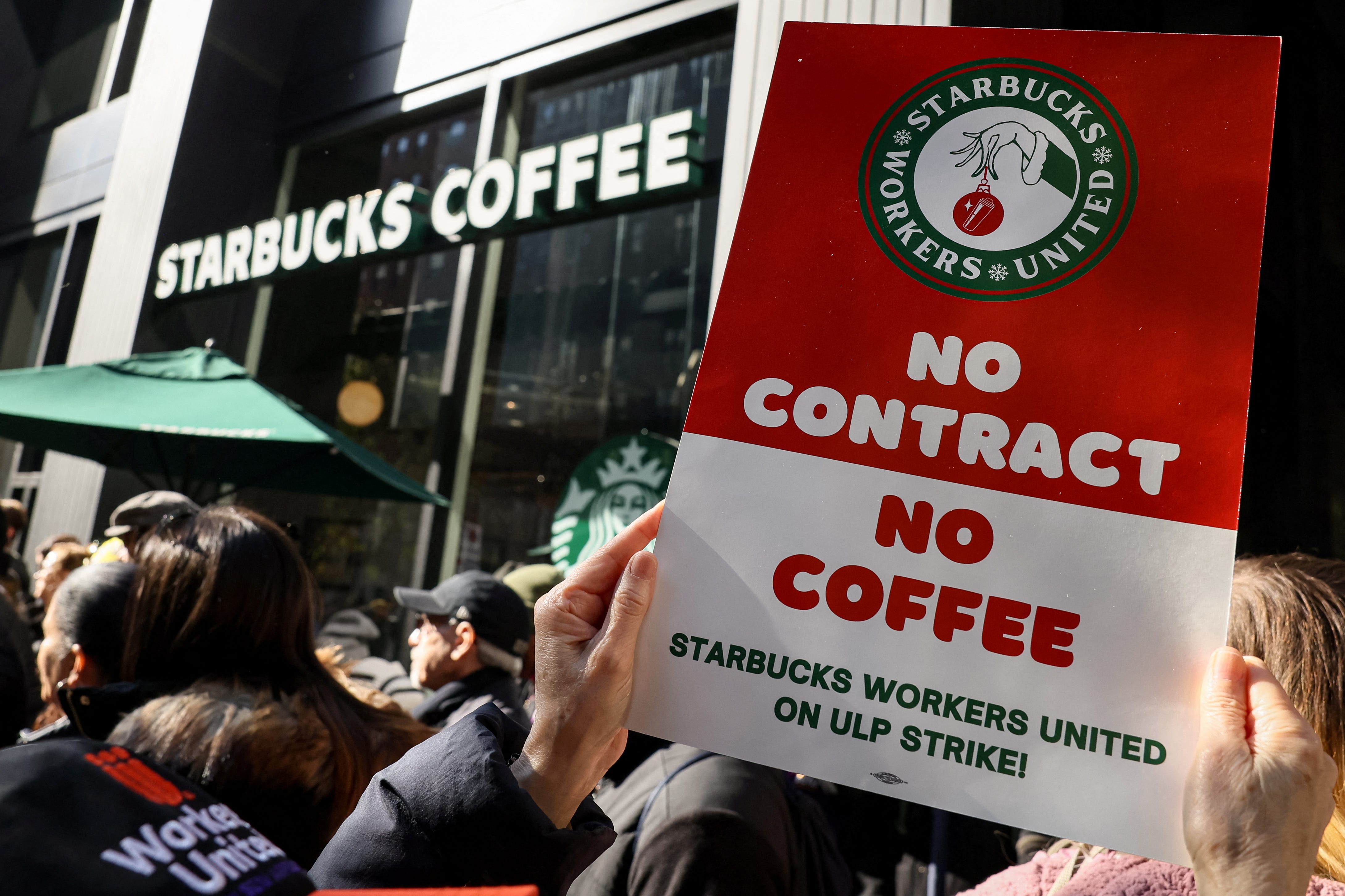 Members of the Starbucks Workers Union and other labor organization picket and hold a rally outside a company owned Starbucks store, during the coffee chain's Red Cup Day event in New York City, U.S., November 16, 2023.