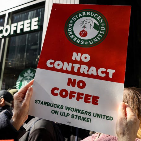 Members of the Starbucks Workers Union and other labor organization picket and hold a rally outside a company owned Starbucks store, during the coffee chain's Red Cup Day event in New York City, U.S., November 16, 2023.