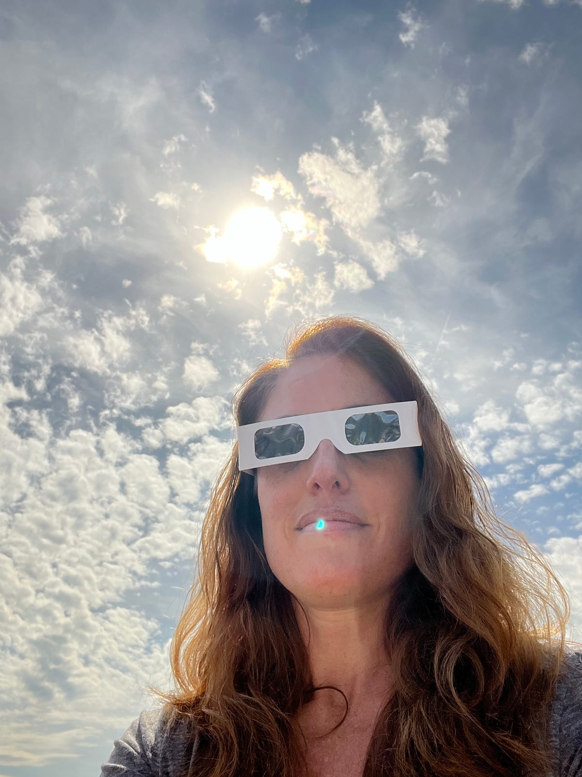 Sent in by Emily Brown, Washington, DC: "I went to the rooftop of my building in DC. Lots of neighbors up there, as well. Not many folks had eclipse glasses so I let them borrow mine for a peek!"