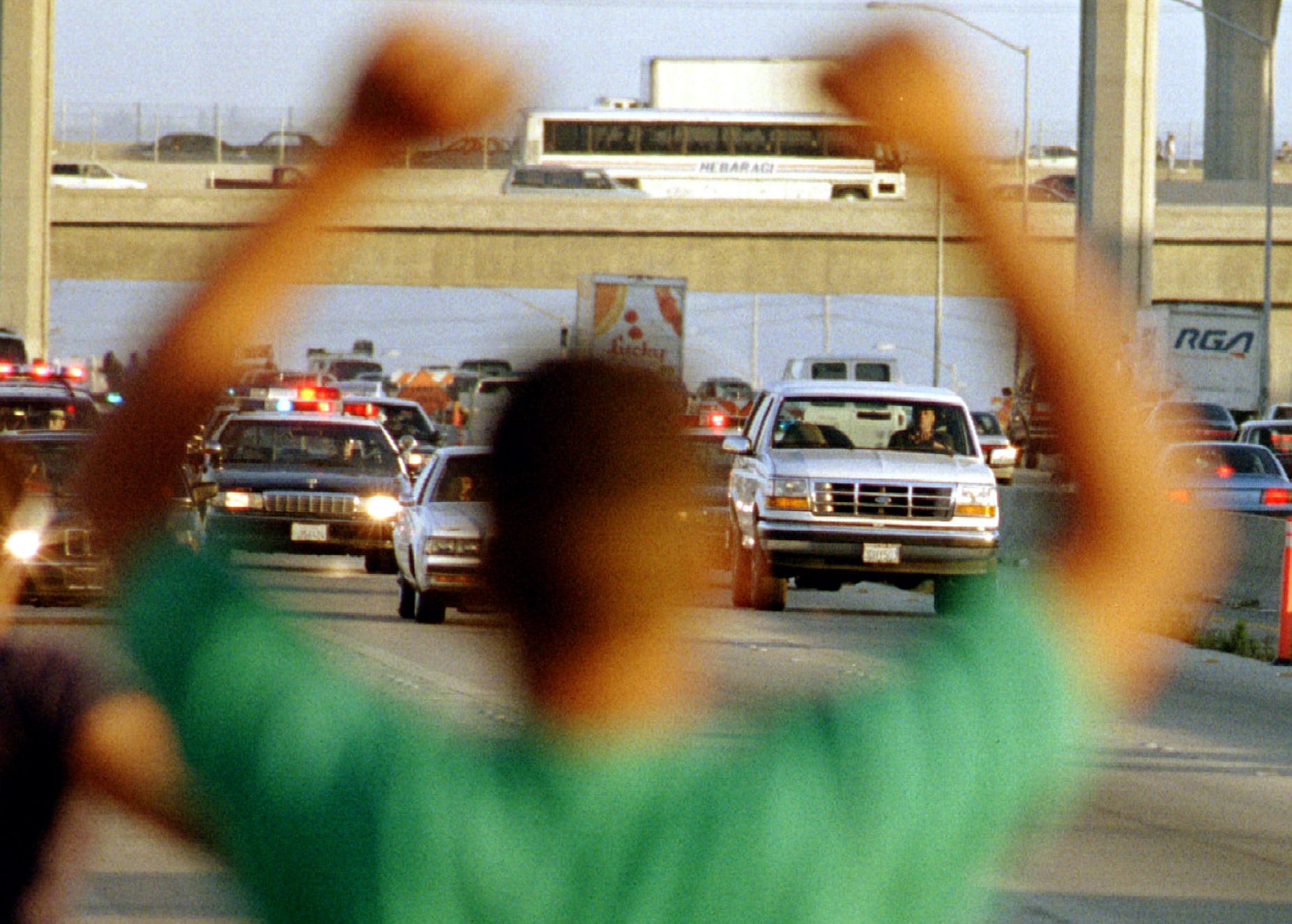 A Man Cheers As The Ford Bronco Carrying Oj Simpson R Is Chased By Dozens Of Police Cars During A