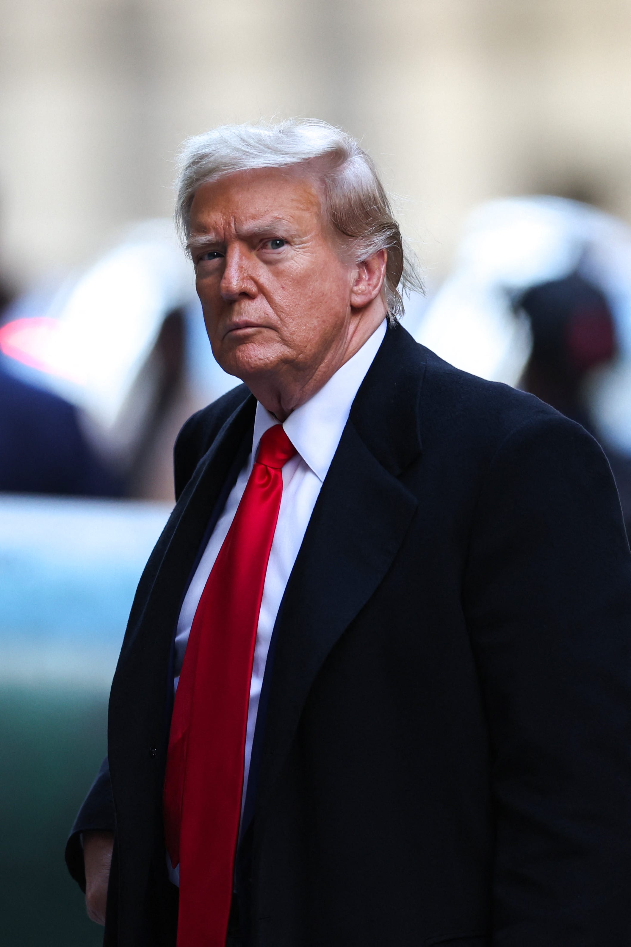 Former US President Donald Trump arrives at 40 Wall Street following his court hearing to determine the date of his trial for allegedly covering up hush money payments linked to extramarital affairs in New York City on March 25, 2024. Judge Juan Merchan rejected demands from Trump's lawyers to delay the first ever criminal trial of a former president for at least 90 days and ordered jury selection to begin on April 15.