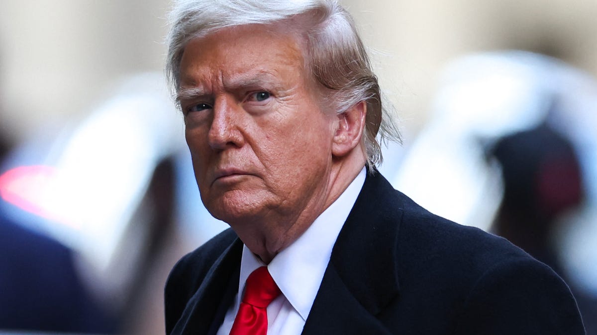 Former US President Donald Trump arrives at 40 Wall Street following his court hearing to determine the date of his trial for allegedly covering up hush money payments linked to extramarital affairs in New York City on March 25, 2024. Judge Juan Merchan rejected demands from Trump's lawyers to delay the first ever criminal trial of a former president for at least 90 days and ordered jury selection to begin on April 15.