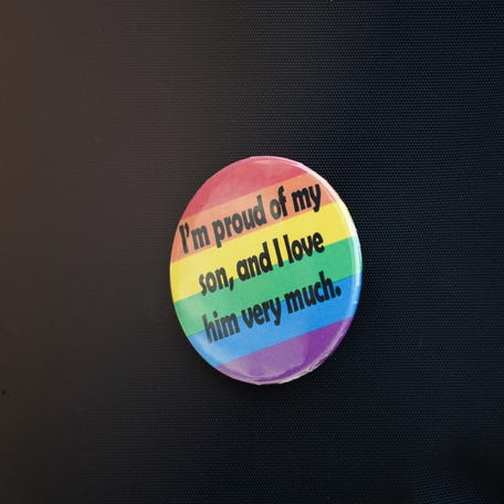 LGBTQ+ advocate button reads, 