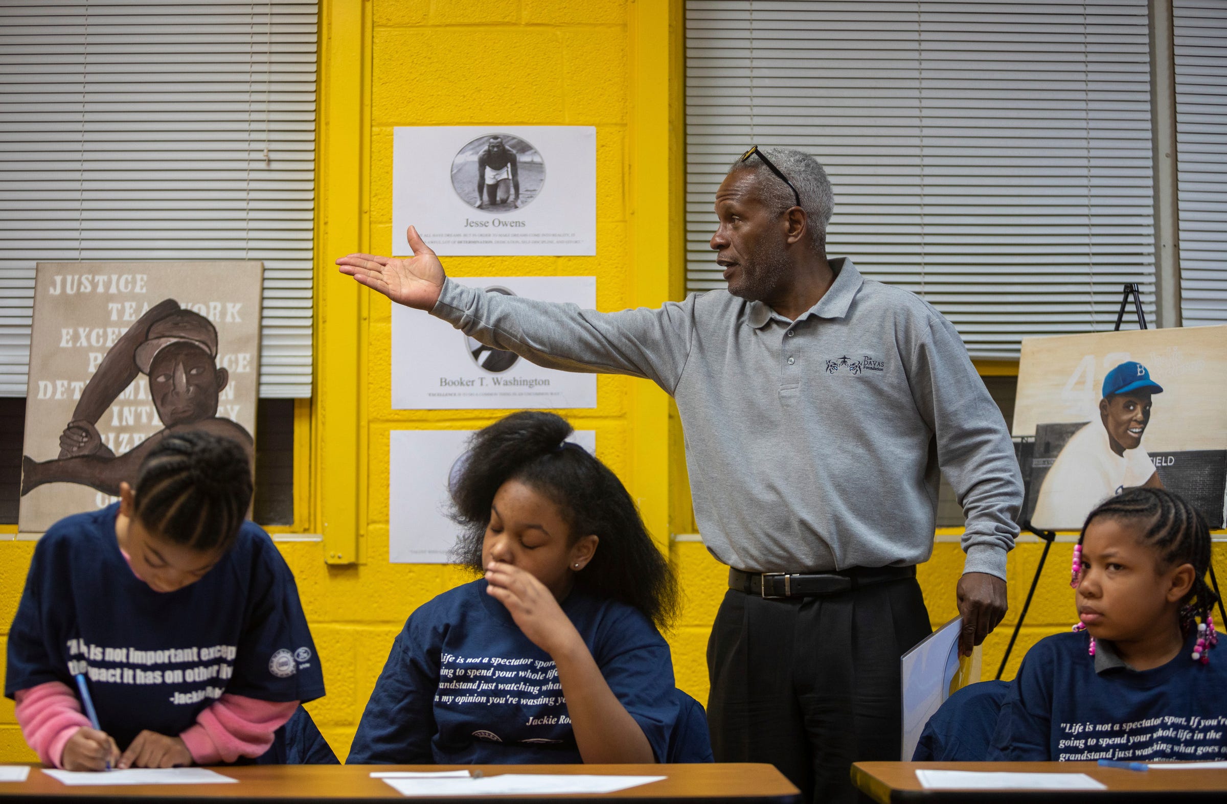 Brooklyn Johnson, (from the left) Samya Jacks, and Morgan McDonald listen to Sam Abrams (standing), founder of The Davas Foundation, teach a Nine Values of an American Legend lesson inside the Tindal Activity Center in Detroit on Wednesday, April 10, 2024.