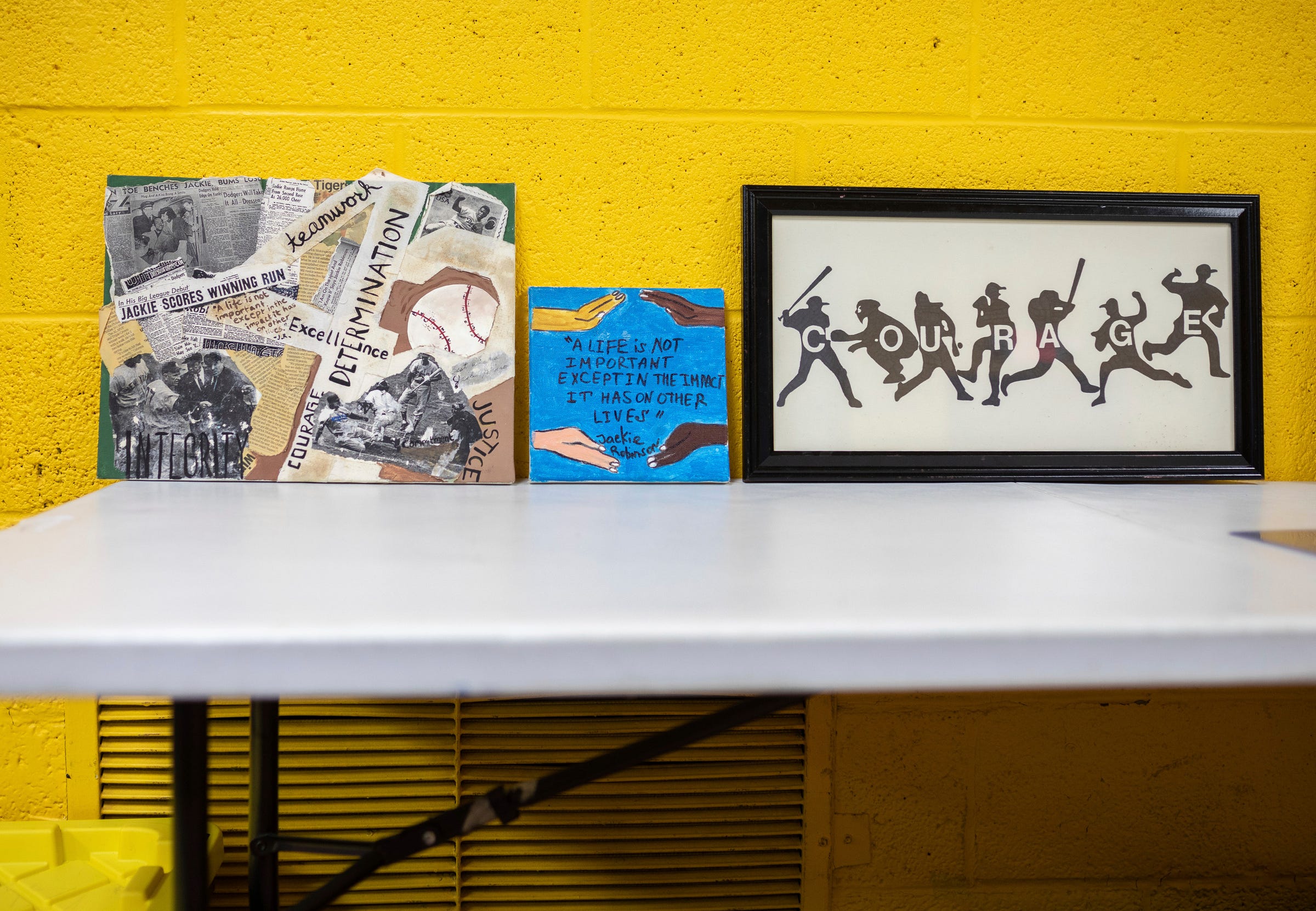 Sam Abrams, 56, founder of The Davas Foundation, decorated a room with Jackie Robinson paintings and picture frames during a Nine Values of an American Legend lesson inside the Tindal Activity Center in Detroit on Wednesday, April 10, 2024.
