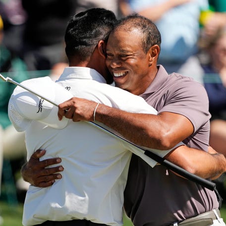 Jason Day greets Tiger Woods on the 18th green in the second round.