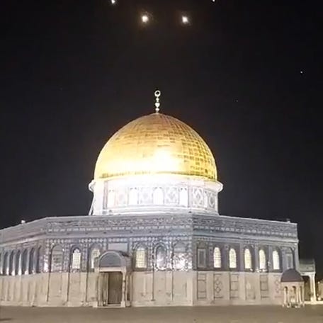 An image-grab from a video taken early on April 14, 2024, shows rocket trails in the sky above the Al-Aqsa Mosque compound in Jerusalem. Iran launched its first-ever direct attack on Israeli territory late Saturday, marking a major escalation of the long-running covert war between the regional foes and sparking fears of a broader conflict breaking out.
