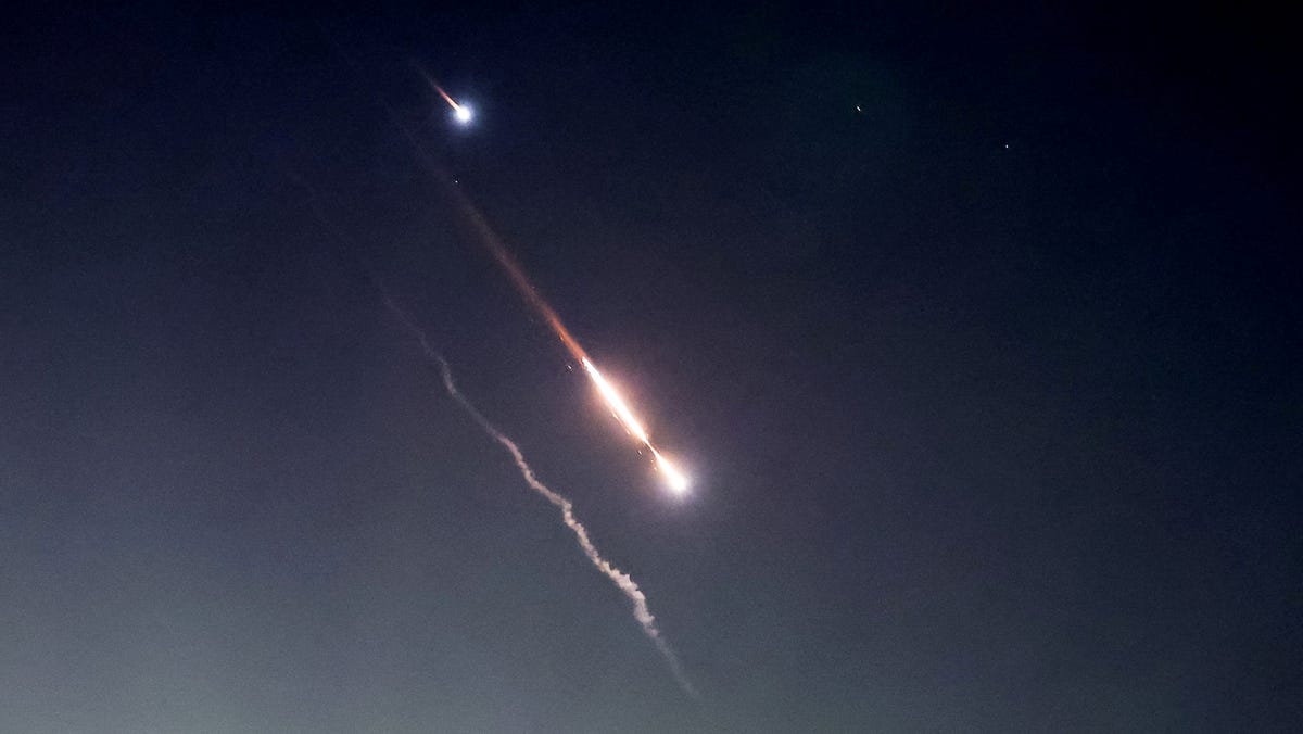 Objects are seen in the sky above Jerusalem after Iran launched drones and missiles towards Israel, in Jerusalem on April 14, 2024.