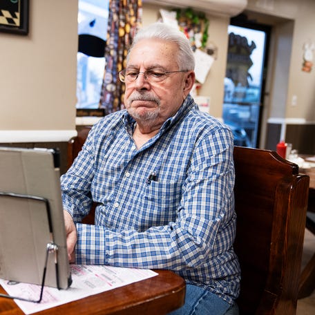 Anthony Milidantri, a retired electrician, plays word games as he sits for breakfast at LoriÕs Corner Kitchen in Ariel, PA.on March 28, 2024.