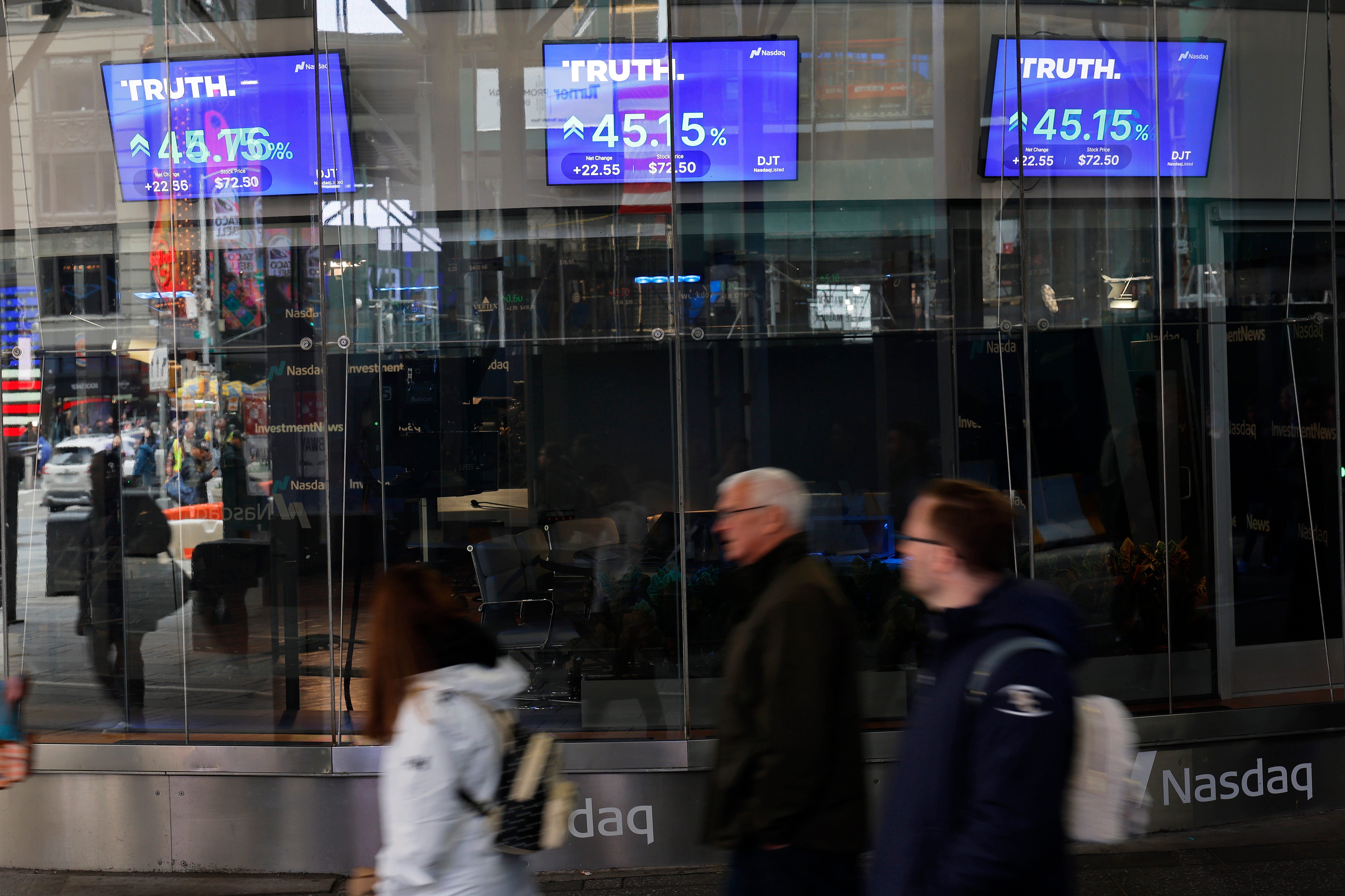 NEW YORK, NEW YORK - MARCH 26: Trump Media & Technology Group stock market trading information is seen on a television at the Nasdaq Marketplace on March 26, 2024 in New York City. Trump Media & Technology Group, the owner of struggling social media platform Truth Social owned by former President Donald Trump, began trading as a public company at Nasdaq's opening bell under the ticker symbol DJT. he stock rose about 50% at the market open.