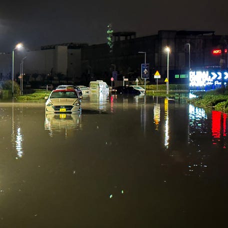 Vehicles are stranded on a flooded street following heavy rains in Dubai early on April 17, 2024. Dubai, the Middle East's financial center, has been paralyzed by the torrential rain that caused floods across the UAE and Bahrain and left 18 dead in Oman on April 14 and 15.
