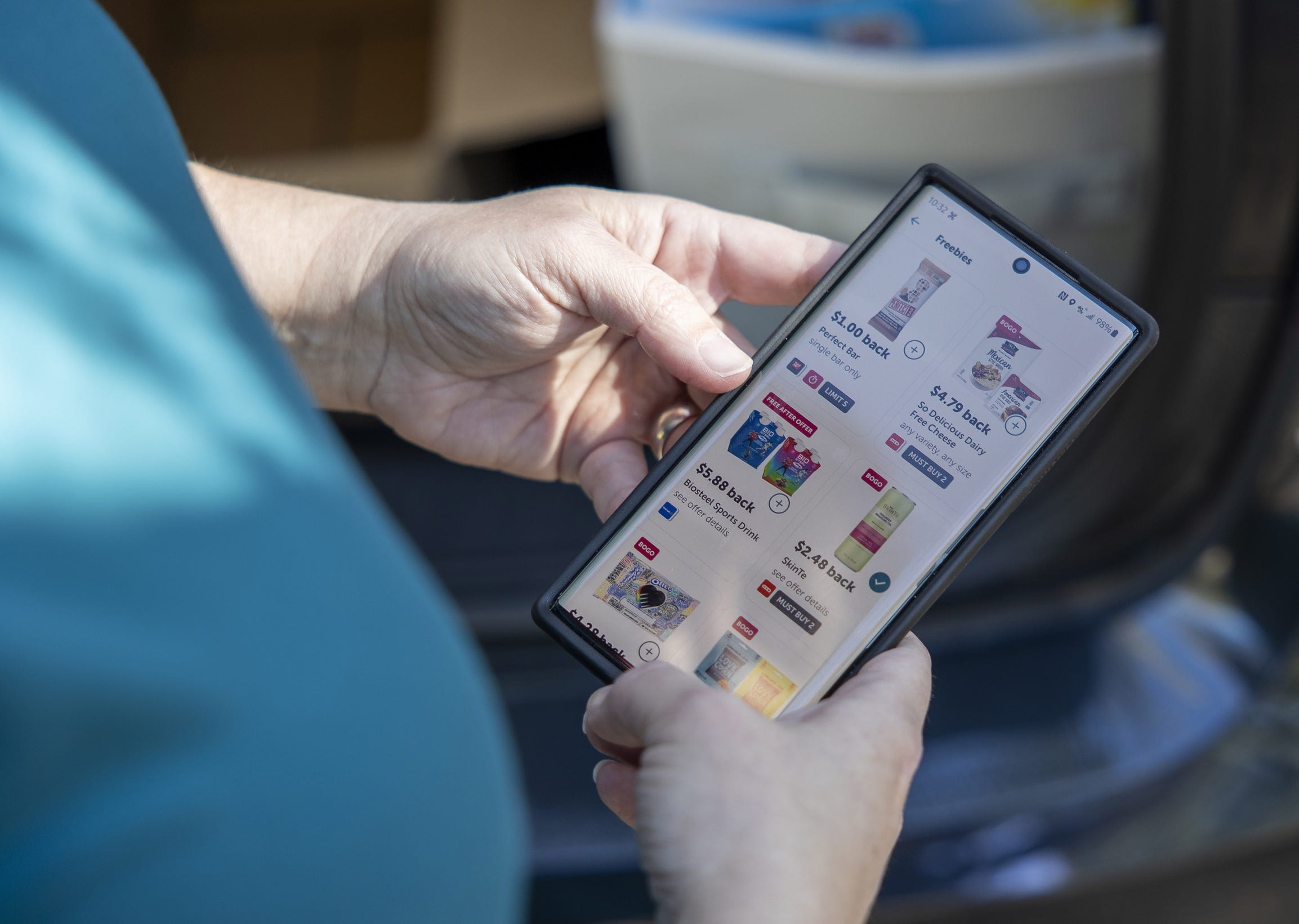 Sep 27, 2022; San Antonio, Texas, USA; Jennifer King, a â€œcouponerâ€ and budget shopper, uses her phone to check an app for rebate deals after stocking a self-serve food pantry outside of St. Lukeâ€™s Episcopal Church in San Antonio, Texas, on Tuesday, Sept. 27, 2022. Mandatory Credit: Nick Wagner-USA TODAY