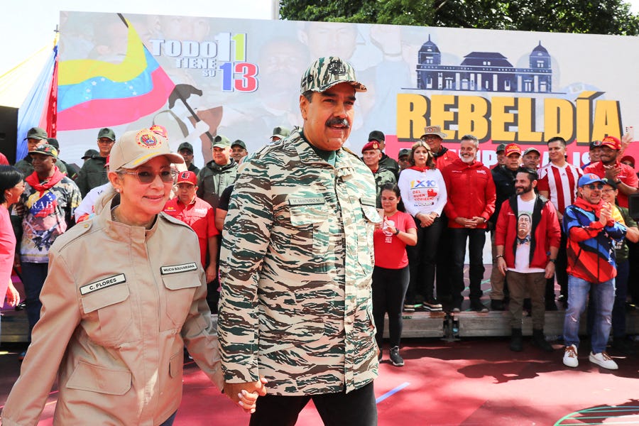 This handout picture released by the Venezuelan Presidency shows Venezuelan President Nicolas Maduro (C) and First Lady Cilia Flores arriving at a political rally in Caracas on April 13, 2024. Venezuelan President Nicolás Maduro proposed on Saturday a constitutional reform to establish life imprisonment and political disqualifications for life for corruption and treason crimes in the South American country, where the highest penalty is 30 years in prison. (Photo by ZURIMAC   CAMPOS / Venezuelan Presidency / AFP)