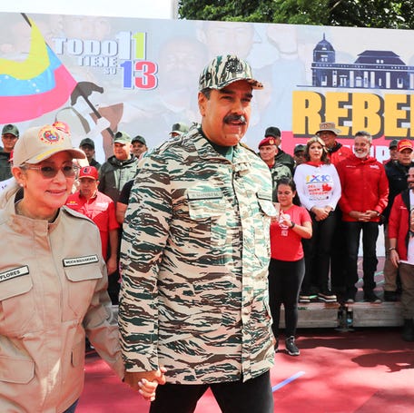 This handout picture released by the Venezuelan Presidency shows Venezuelan President Nicolas Maduro (C) and First Lady Cilia Flores arriving at a political rally in Caracas on April 13, 2024. Venezuelan President Nicolás Maduro proposed on Saturday a constitutional reform to establish life imprisonment and political disqualifications for life for corruption and treason crimes in the South American country, where the highest penalty is 30 years in prison. (Photo by ZURIMAC   CAMPOS / Venezuelan Presidency / AFP)