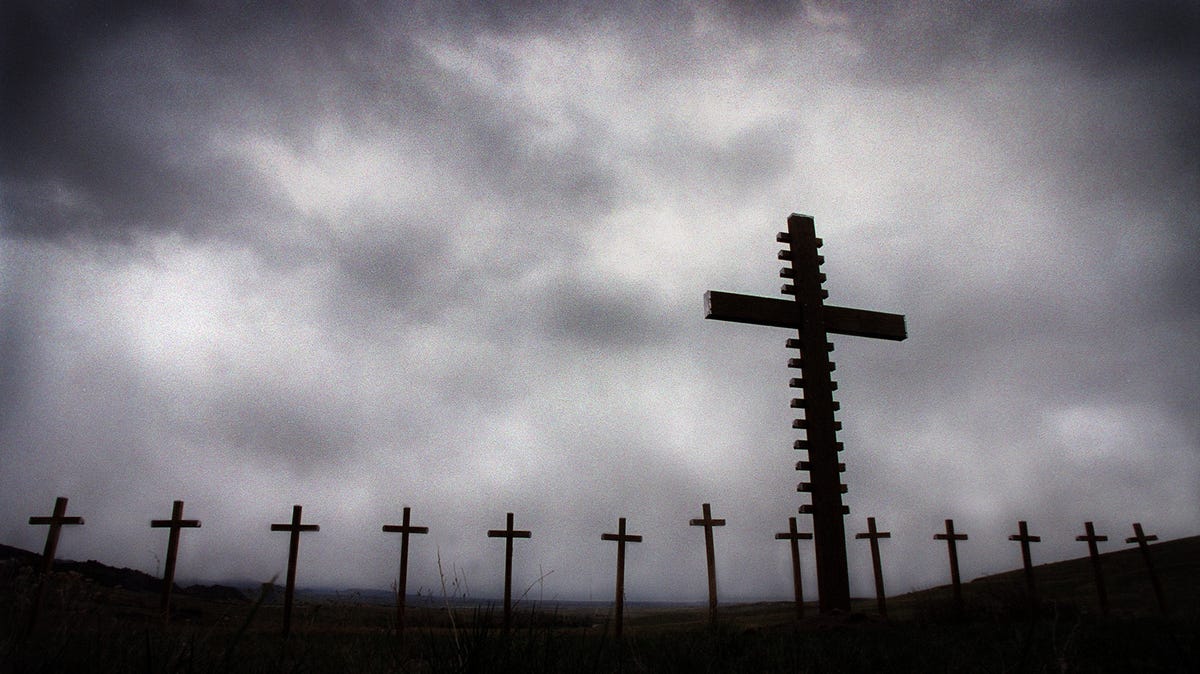 A line of 13 crosses honoring the victims of the Columbine shootings are anchored by one large cross that bears their names on a piece of property owned by Ron Aigner, inside Roxborough Park. Aigner offered the location when the crosses were removed from Rebel Hill at Clement Park on April 30, 1999.