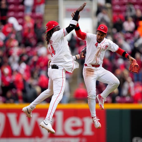 Cincinnati Reds shortstop Elly De La Cruz (44) and Cincinnati Reds second base Santiago Espinal (4) celebrate the win at the conclusion of the ninth inning of a baseball game against the Los Angeles Angels, Sunday, April 21, 2024, at Great American Ball Park in Cincinnati.