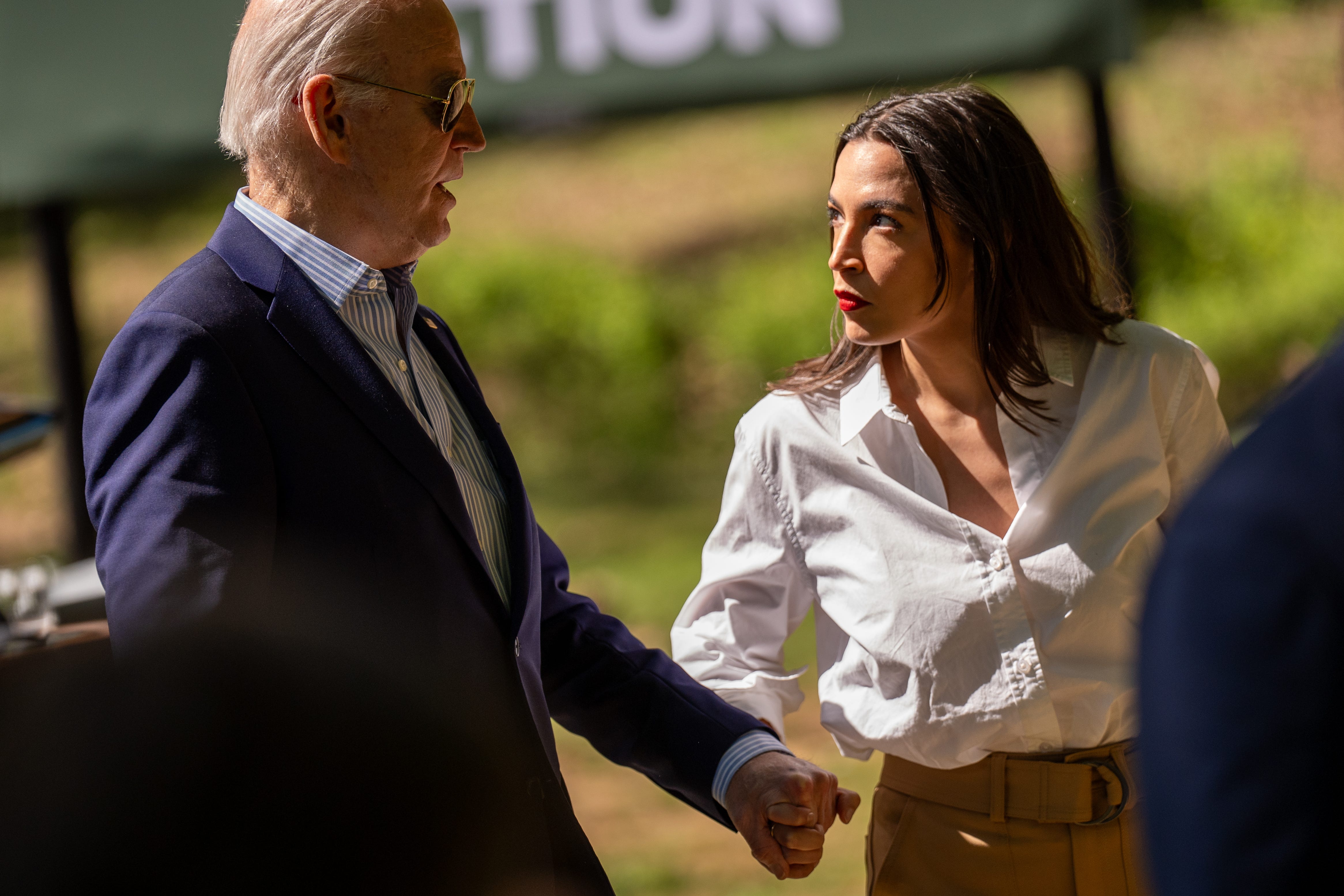 TRIANGLE, VIRGINIA - APRIL 22: U.S. President Joe Biden speak with Rep. Alexandria Ocasio-Cortez (D-NY) following a speech at Prince William Forest Park on April 22, 2024 in Triangle, Virginia. Biden announced a new seven billion dollar "Solar For All" program with the Environmental Protection Agency as well as an American Climate Corps initiative while commemorating the 54th anniversary of Earth Day, started in 1970 to raise awareness and support   for environmental protection. (Photo by Andrew Harnik/Getty Images) ORG XMIT: 776135686 ORIG FILE ID: 2148014786