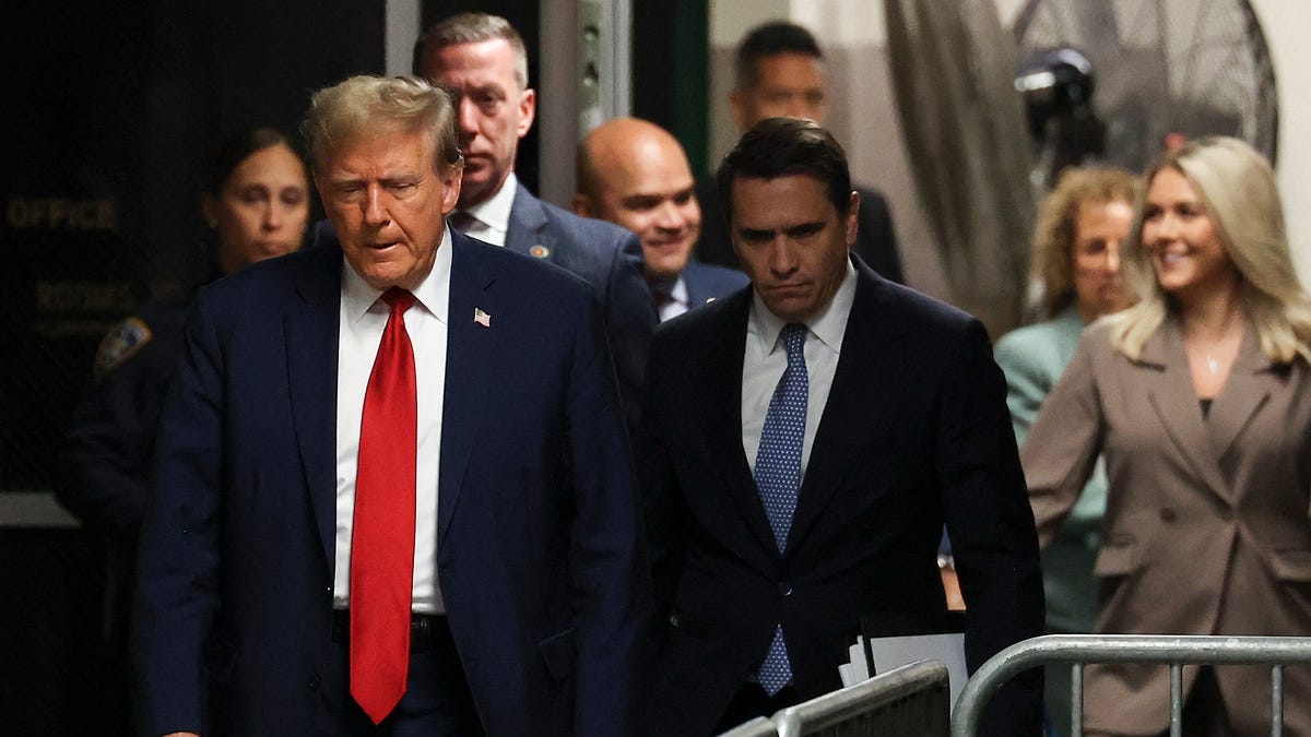 Former President Donald Trump (L) arrives for his trial for allegedly covering up hush money payments linked to extramarital affairs, at Manhattan Criminal Court in New York City on April 23, 2024. Trump faces a contempt of court hearing on Tuesday as part of his historic criminal trial, with New York prosecutors insisting the former president repeatedly violated the gag order issued to prevent him from intimidating witnesses.