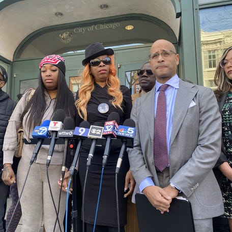 Nicole Banks, center, speaks at a news conference in Chicago following the release of the bodycam footage showing her son Dexter Reed's death. Porscha Banks, Reed's sister, stands to her left, and Andrew M. Stroth, a prominent local civil rights attorney, to her right.