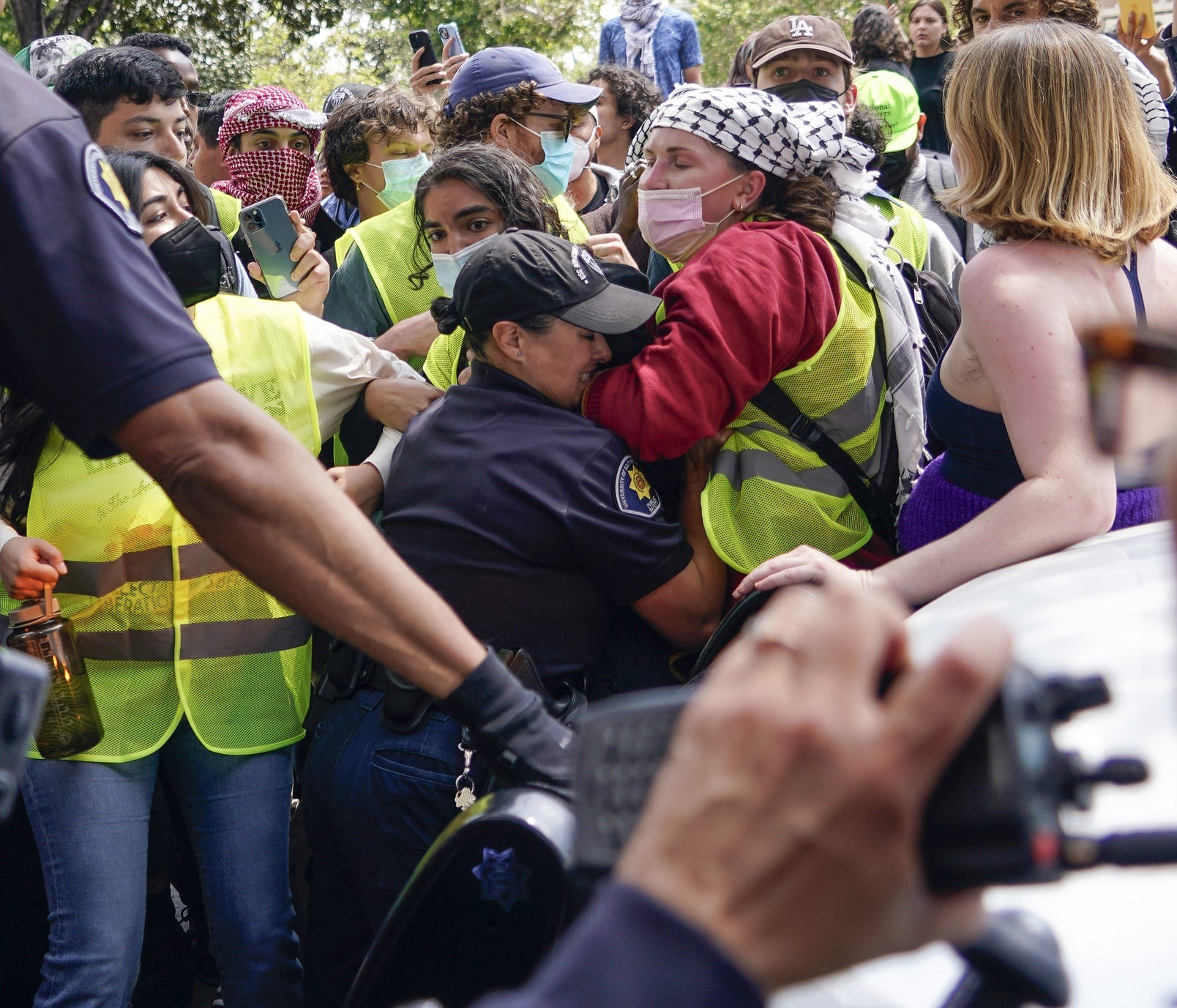 Demonstrators scuffle with security officers on the campus of the University of Southern California. Several hundred people protest the ongoing war in Gaza on the University of Southern California Campus.