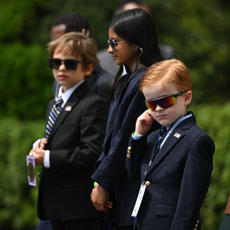 Children take the place of U.S. Secret Service agents as President Joe Biden speaks during a Take Your Child to Work Day welcome on the South Lawn of the White House on April 27, 2023, in Washington, D.C.