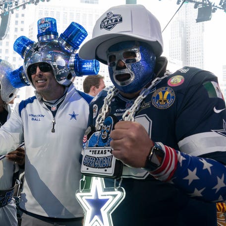 Dallas Cowboys fans pose in the main theater on Thursday, April 25, 2024 for the first day of the NFL Draft in Detroit.