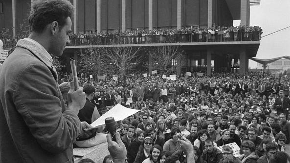 Mario Savio (L), one of the leaders of the Free Speech Movement at the University of California, tells thousands of rally attendees that his group will continue efforts to expand political freedom on the campus on Dec. 4, 2964 in Berkeley, Calif.