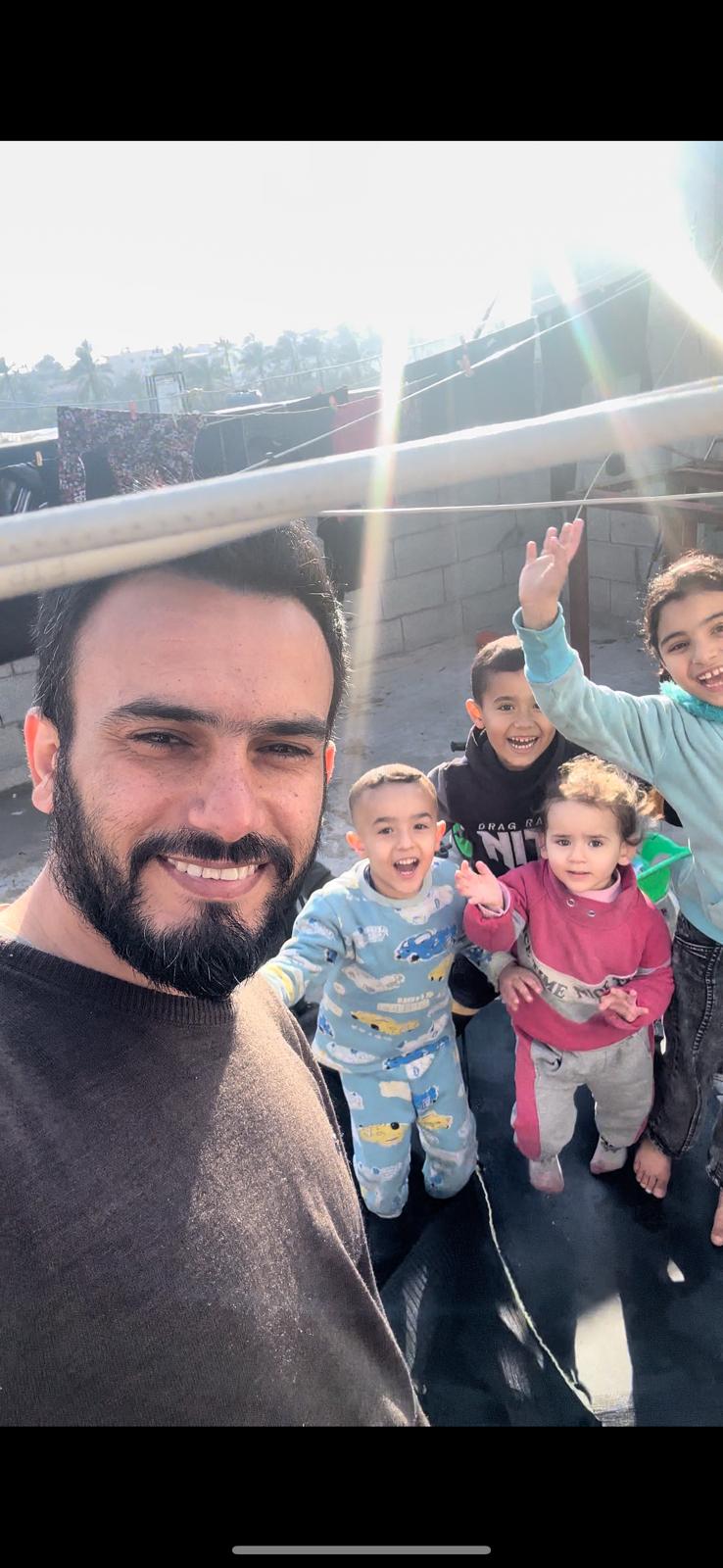Ahmed Jamal, at left, and his son, Jamal, and daughter Teya, center, are pictured with other children in Gaza on April 27, 2024.
