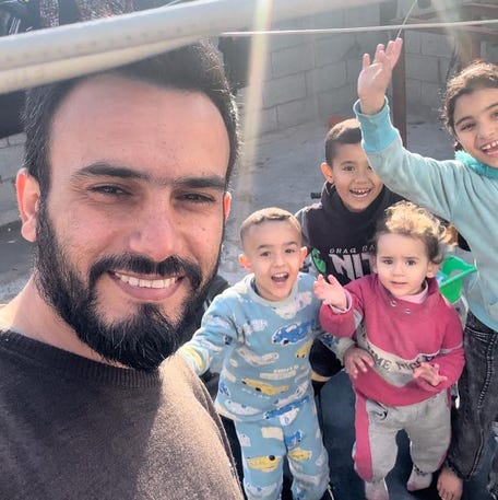 Ahmed Jamal, at left, and his son, Jamal, and daughter Teya, center, are pictured with other children in Gaza on April 27, 2024.