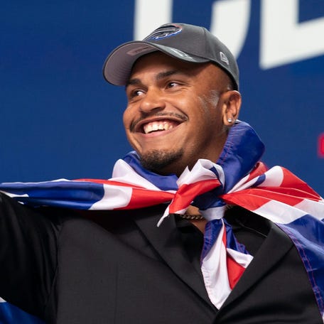 Rugby player Travis Clayton shows his excitement after being drafted by the Buffalo Bills on Saturday, April 27, 2024, during the NFL draft in Detroit.