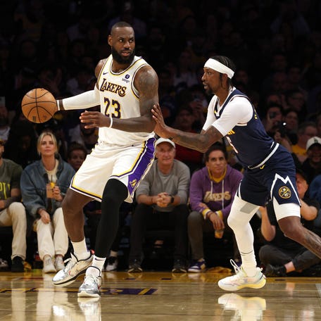 Los Angeles Lakers forward LeBron James (23) dribbles against Denver Nuggets guard Kentavious Caldwell-Pope (5) during the third quarter of Game 4.